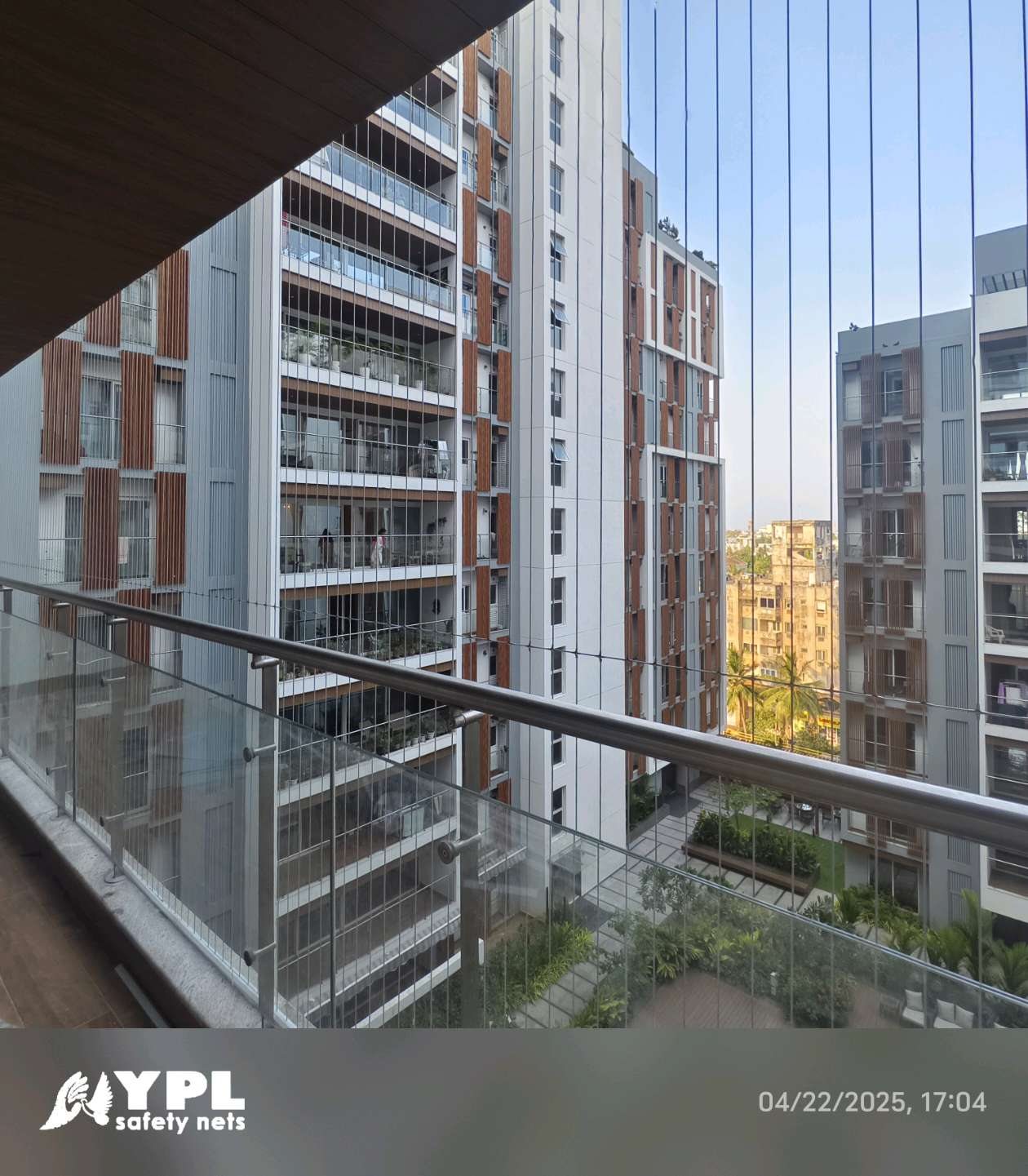 Name-printed invisible grill installed on a high-rise apartment balcony by YPL Safety Nets Chennai