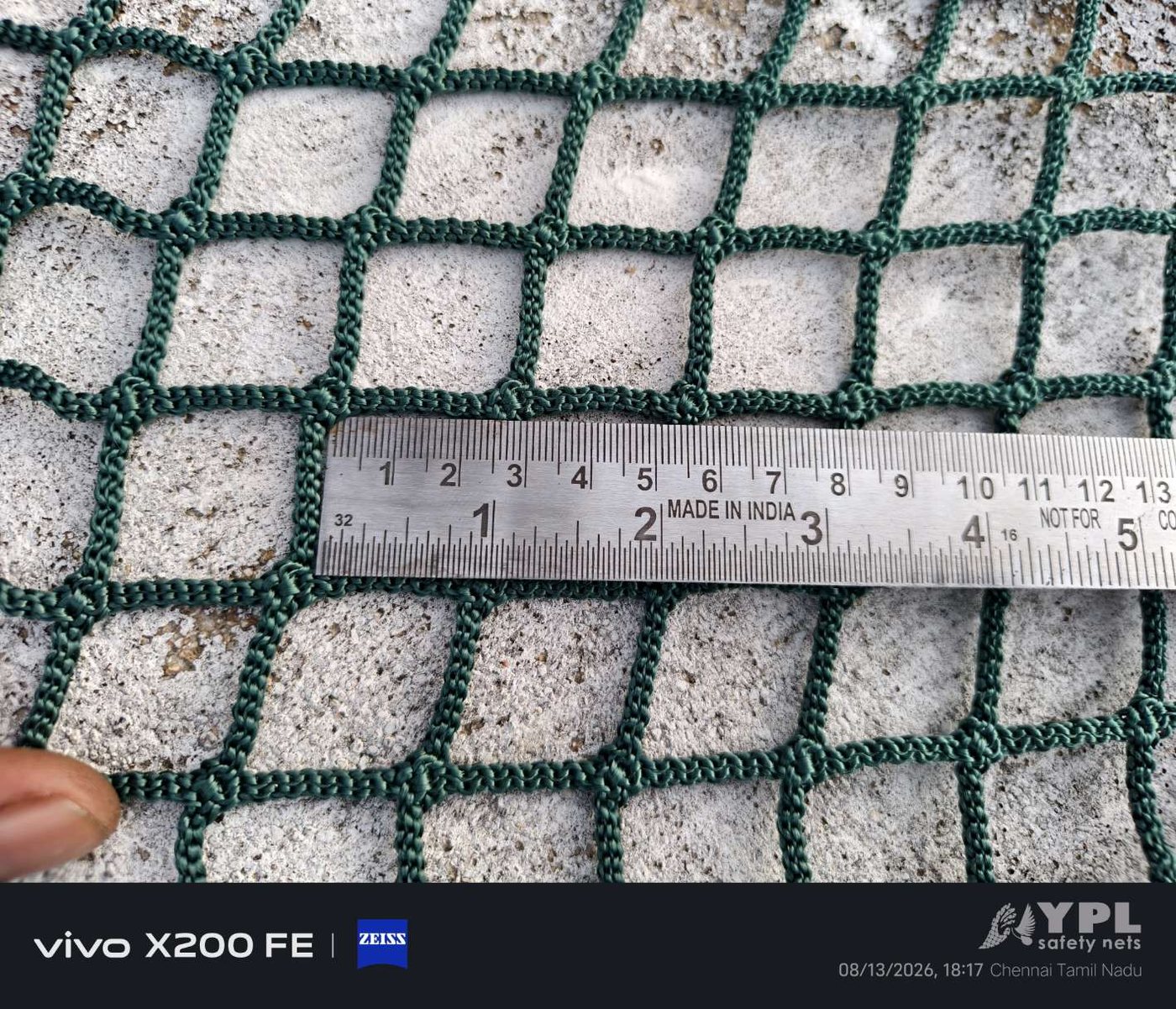 White balcony safety net mesh measured for aperture accuracy before installation by YPL Safety Nets