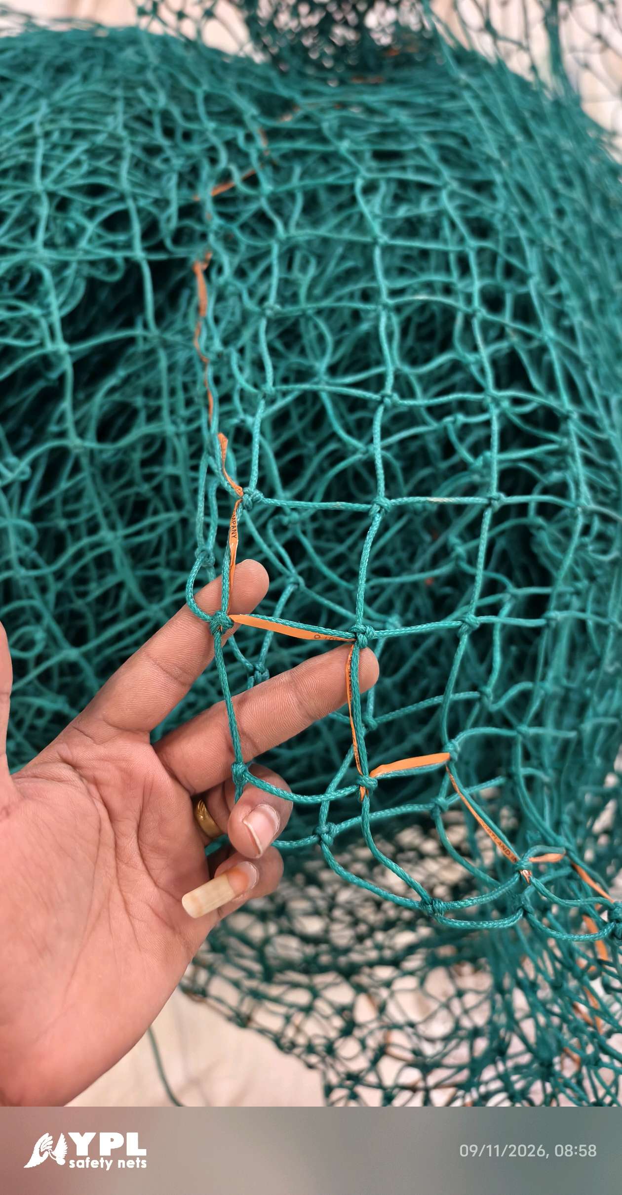 Rope-bordered green safety net panel ready for dispatch