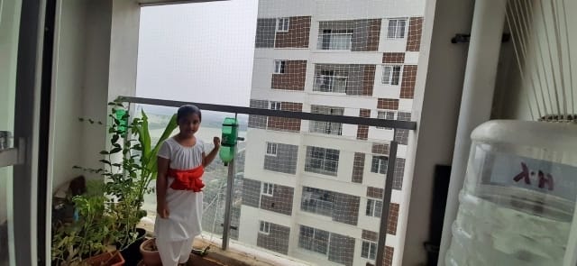 Children safety net on a high-rise apartment balcony installed by YPL Safety Nets — child stands safely at the railing