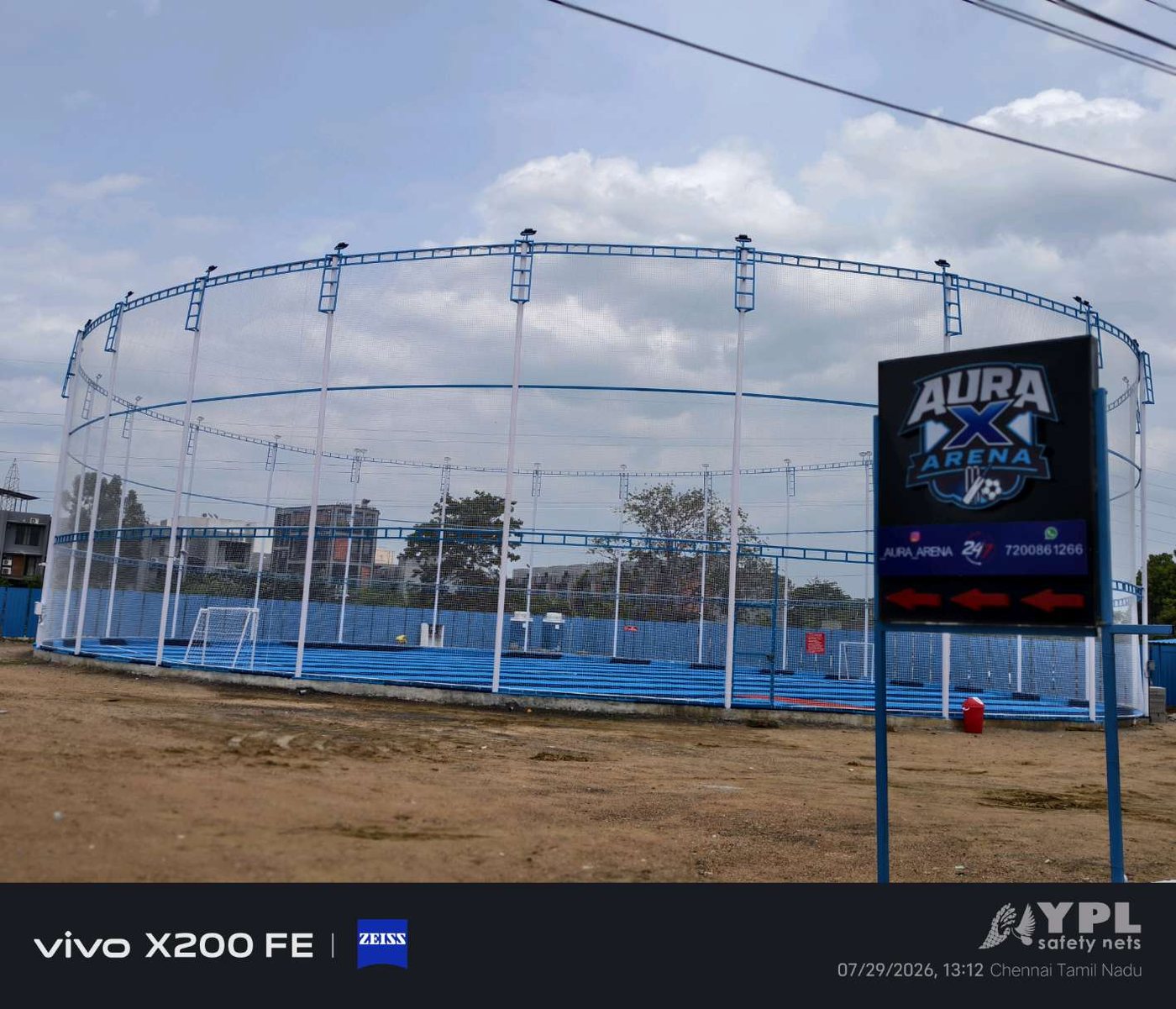 Outdoor sports arena enclosed with tall perimeter nets and floodlight poles installed by YPL Safety Nets