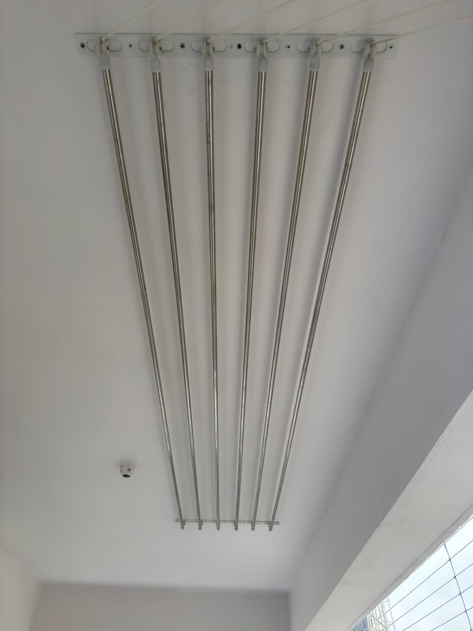 Stainless steel ceiling dryer rods raised neatly against the ceiling