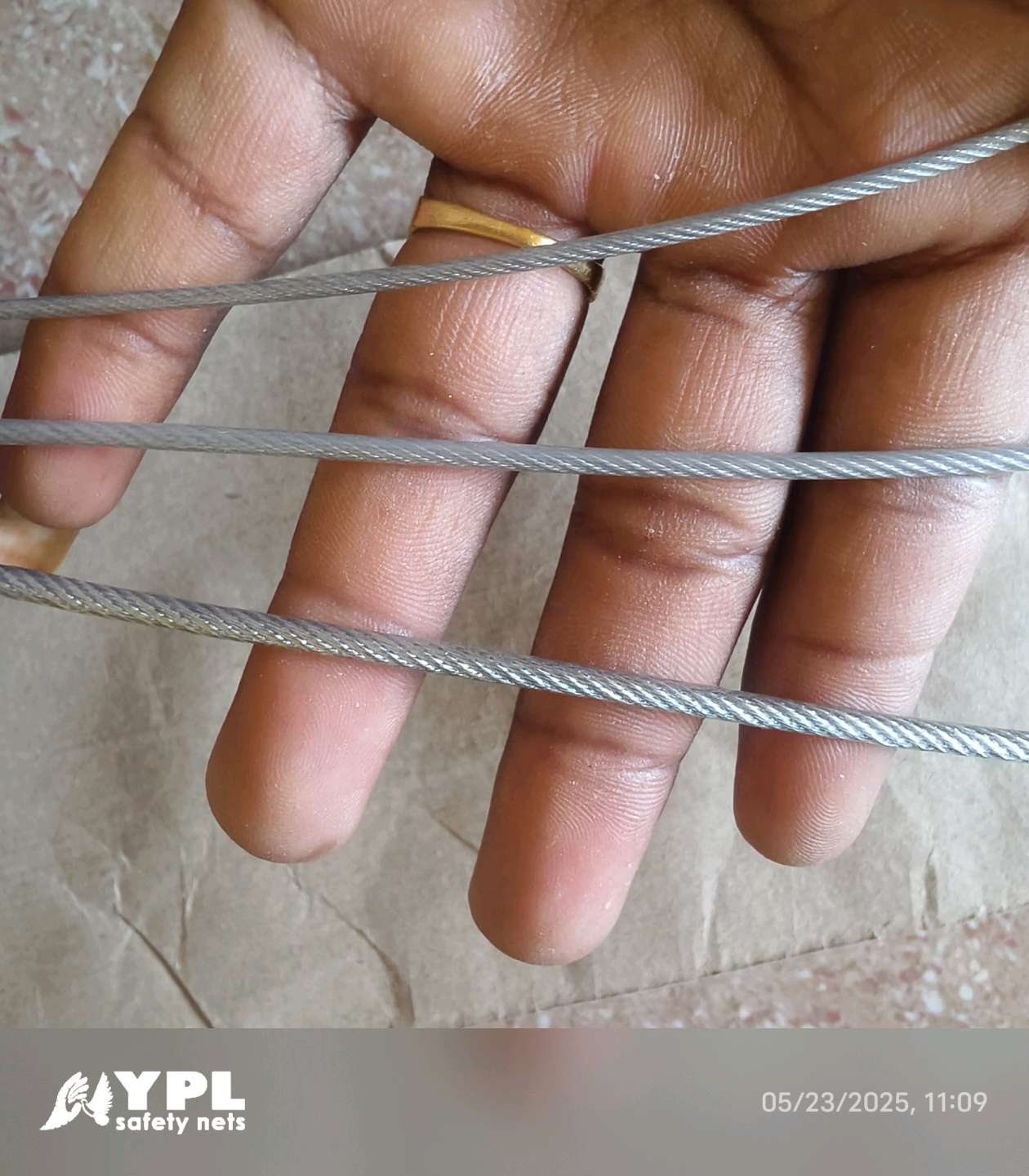 Close-up of stainless steel invisible grill cable and fixing hardware used by YPL Safety Nets