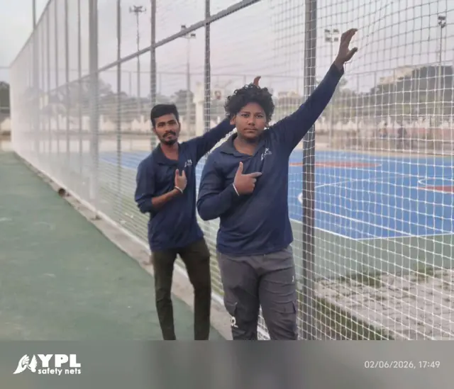 Tall ball-stop net cage around a blue multi-sport court installed by YPL Safety Nets Chennai