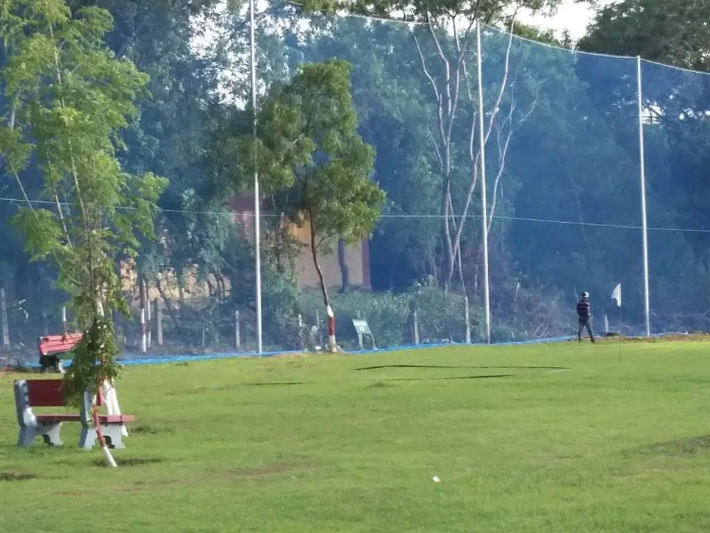 Golf driving range barrier net on tall poles installed by YPL Safety Nets for ball containment