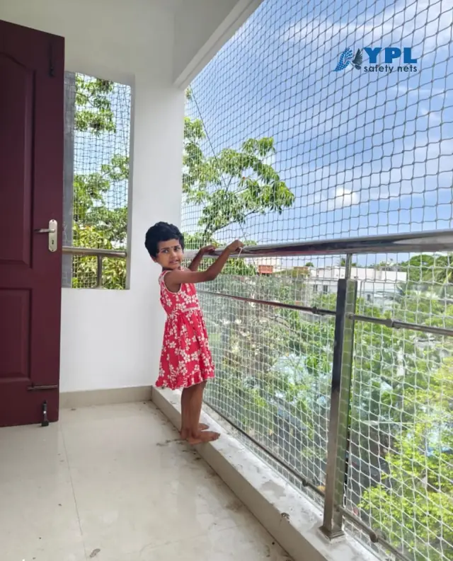Balcony safety net fitted across a Chennai apartment balcony with an open city view