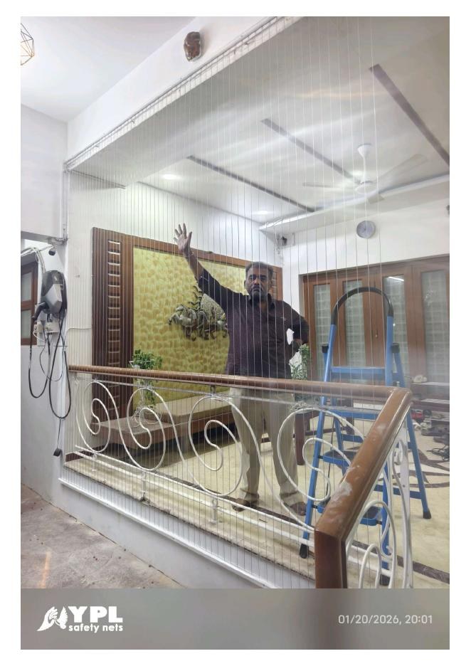 Floor-to-ceiling staircase safety net beside an indoor railing for Safety nets near me by YPL Safety Nets Chennai. Floor-to-ceiling staircase safety net beside an indoor railing for Safety nets near me by YPL Safety Nets Chennai.