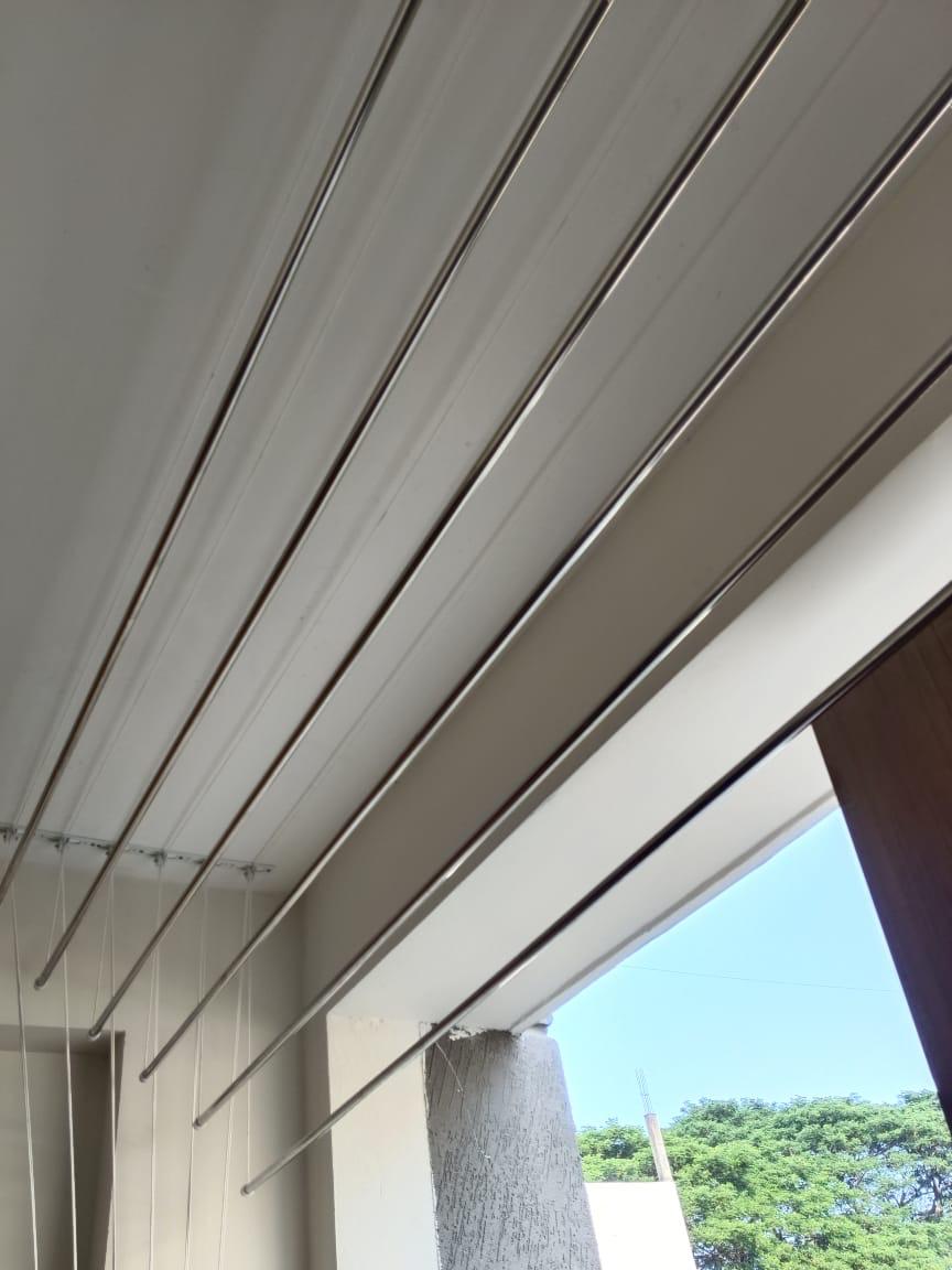 Close view of polished stainless steel ceiling dryer rods