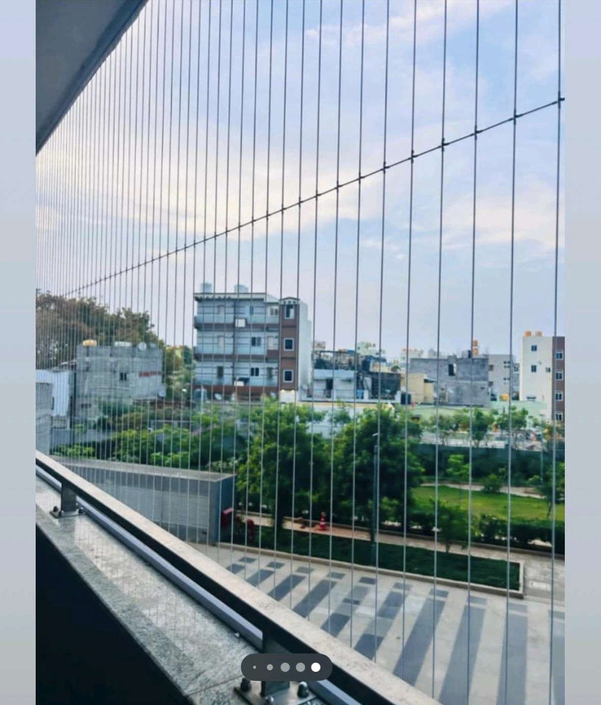 Invisible grill fitted balcony keeping the city skyline view clear, installed by YPL Safety Nets Chennai