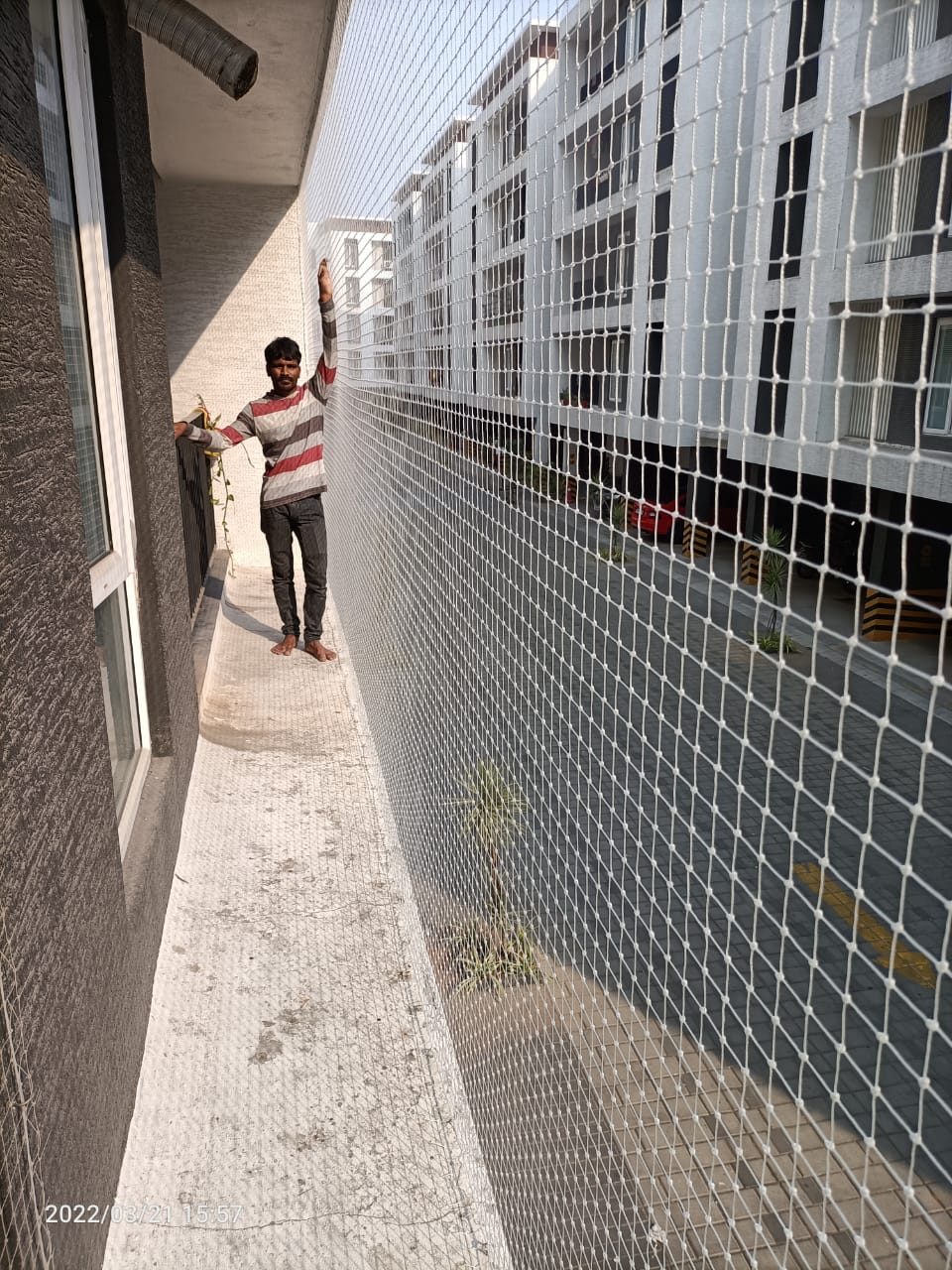 Finished corridor balcony safety net covering an apartment walkway edge to edge by YPL Safety Nets Chennai