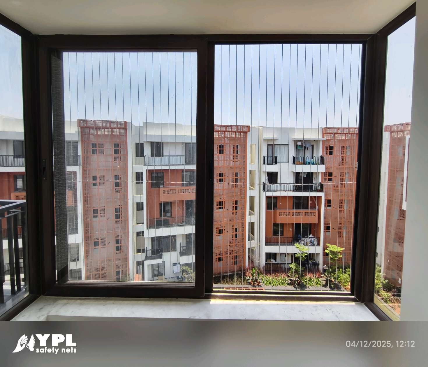 Protected window opening with an unobstructed outside view for Invisible grills Chennai by YPL Safety Nets Chennai.