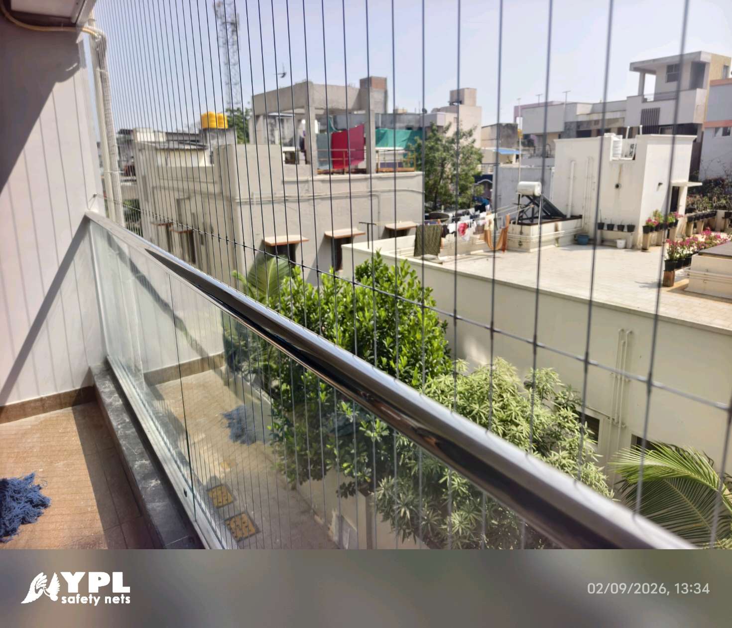 Wide balcony protected with a nearly invisible grill installation by YPL Safety Nets Chennai